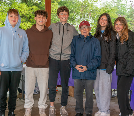 Mark Schonwetter, Holocaust survivor, celebrates with JFTL Mitzvah Project participants.